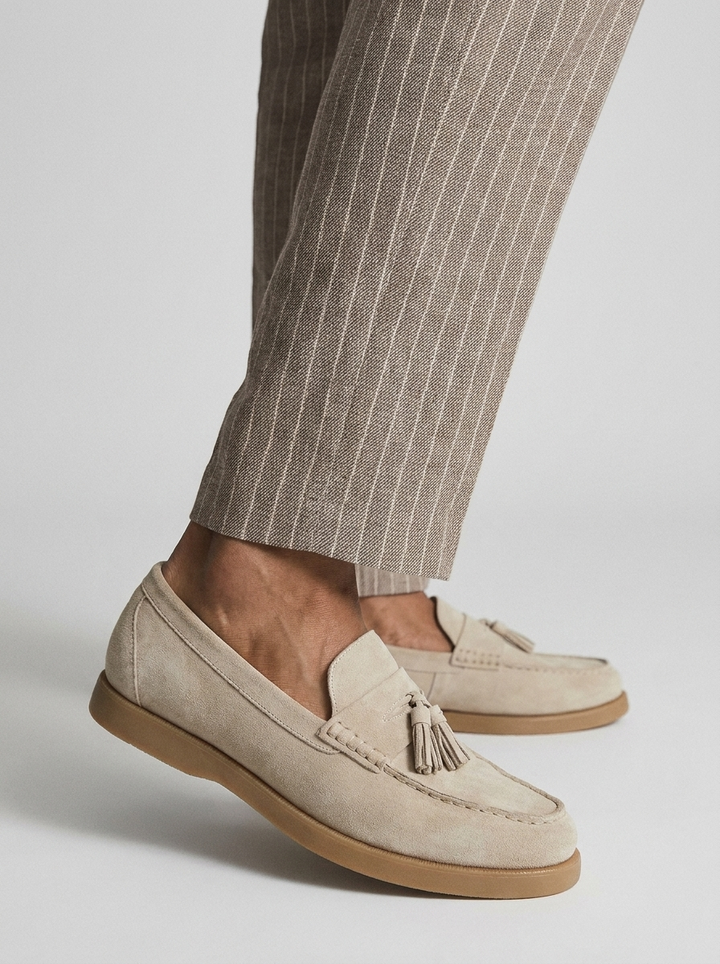 Beige men's tassel loafers with moc toe and low brown sole