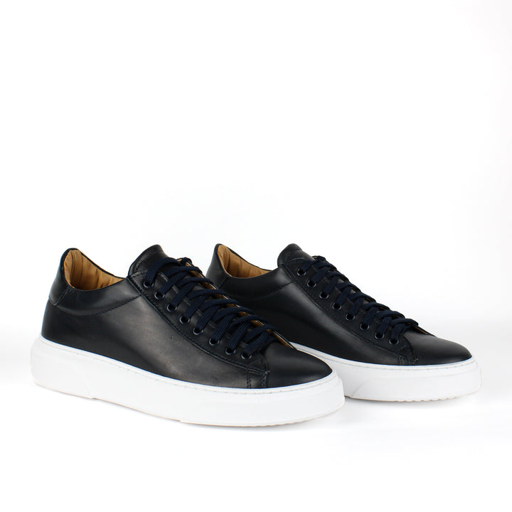 Black low-top lace-up sneaker with white platform sole
