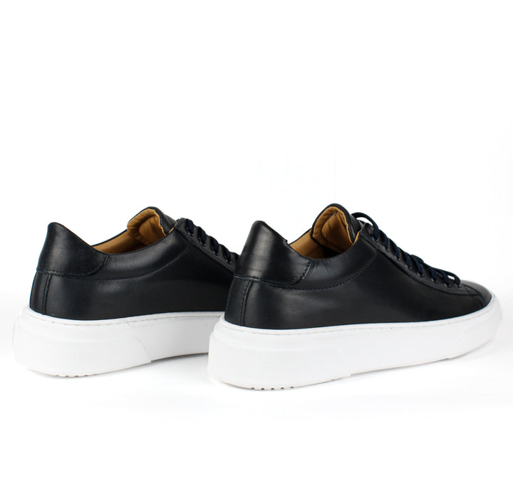 Black low-top lace-up sneaker with white platform sole