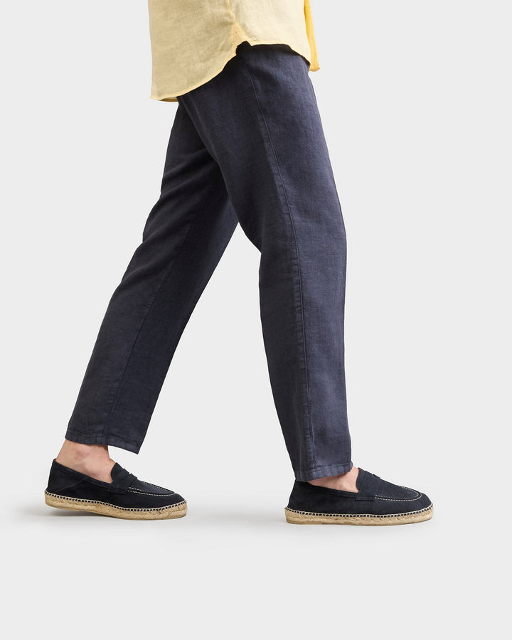Black suede loafers with woven espadrille sole and white stitching