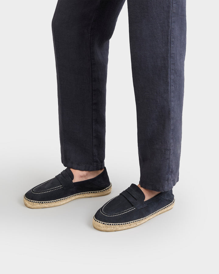 Black suede loafers with woven espadrille sole and white stitching