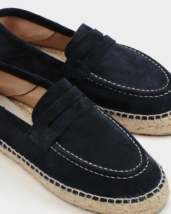 Black suede loafers with woven espadrille sole and white stitching