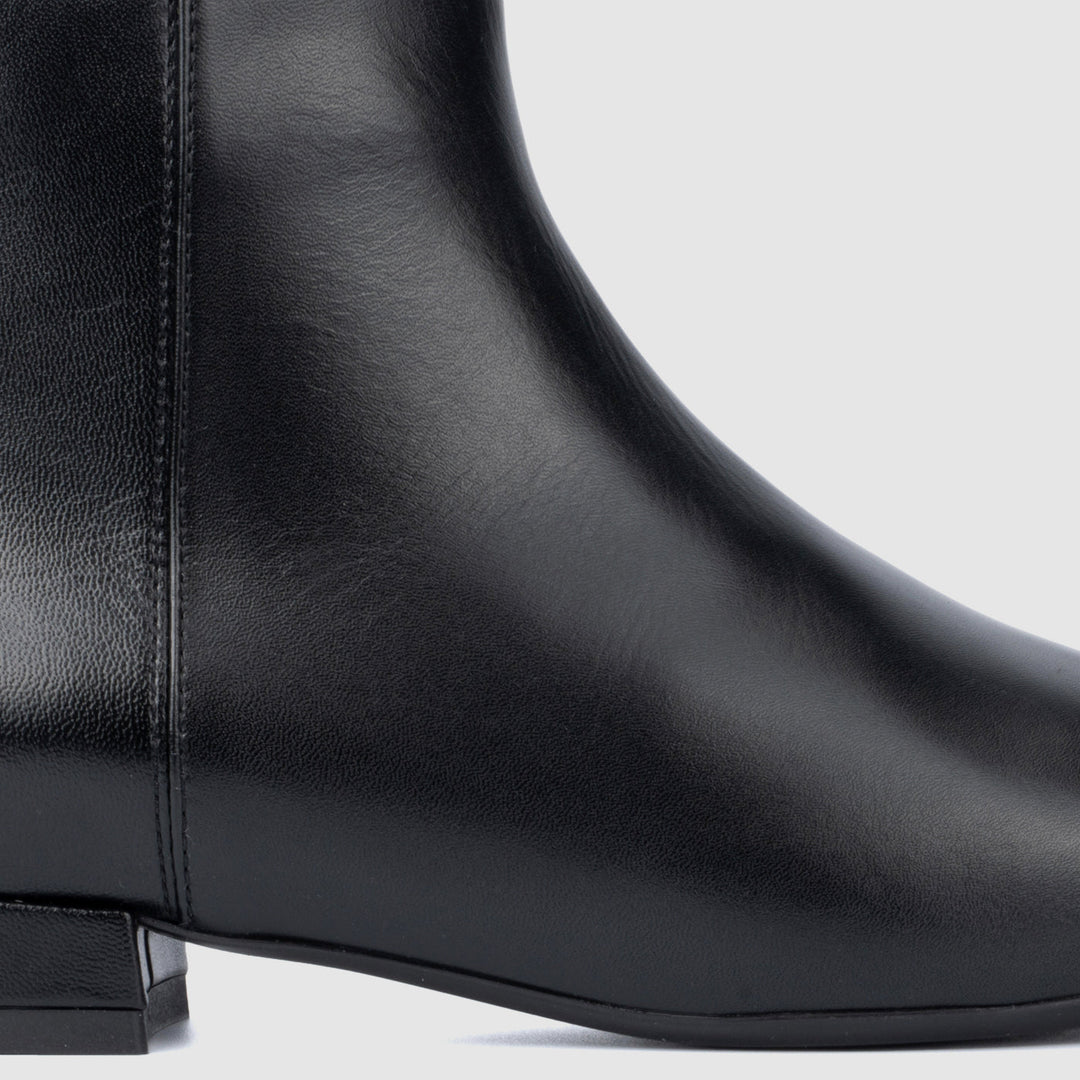 Women's black pointed toe ankle boots with side zips and low heels