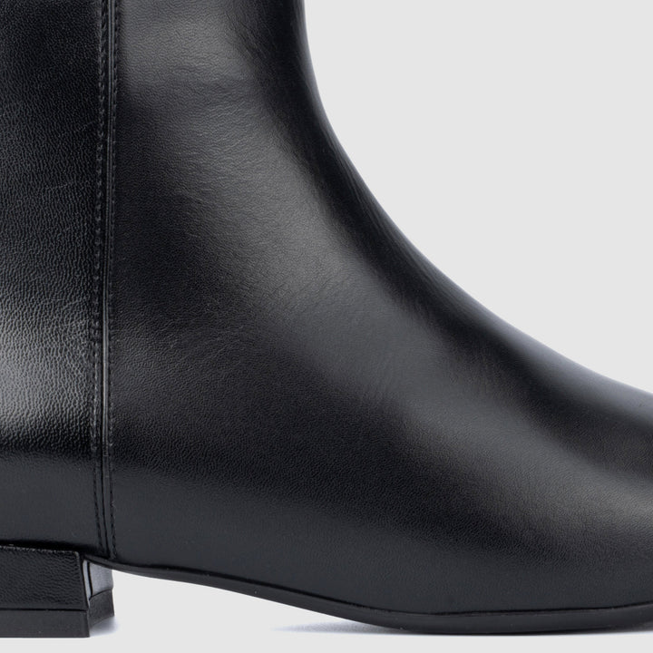 Women's black pointed toe ankle boots with side zips and low heels