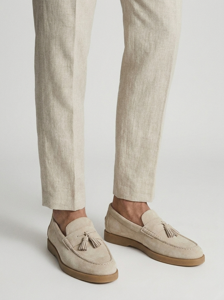 Beige men's tassel loafers with moc toe and low brown sole