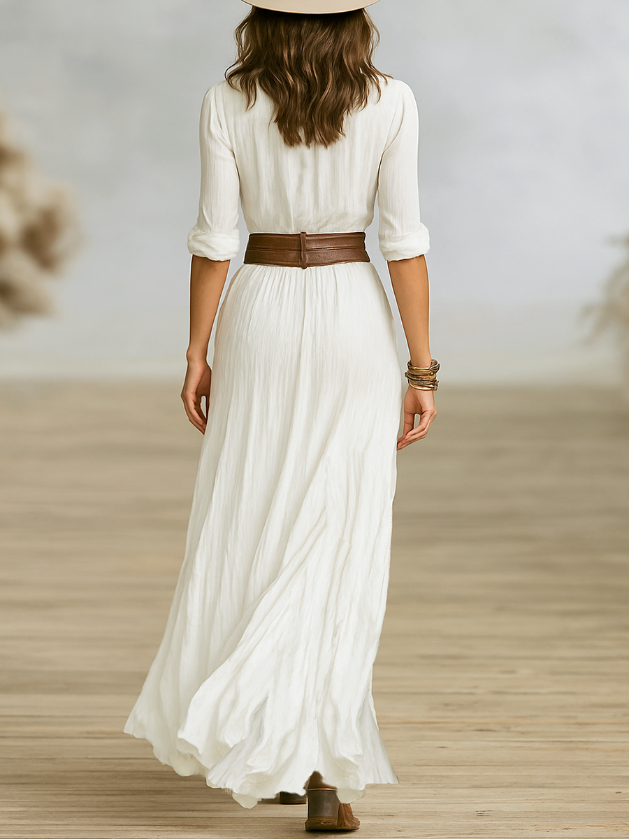 Women's pleated white maxi dress with deep V-neckline, long sleeves, belt and asymmetrical side-split hem