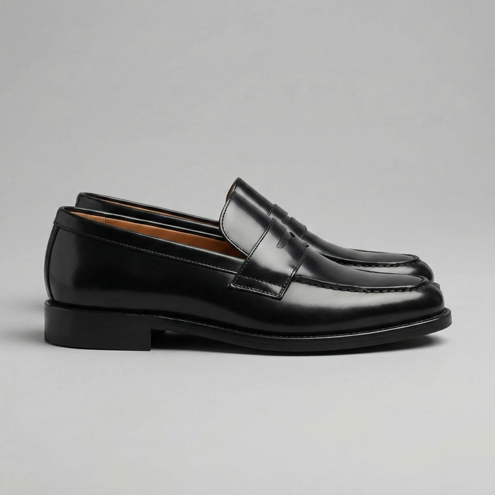 Men's black glossy penny loafers with rounded toes and low heels