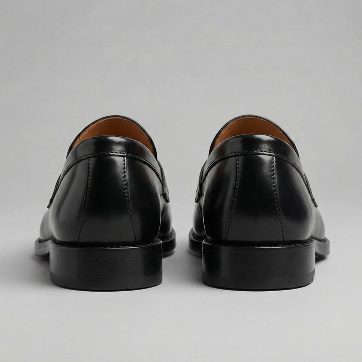 Men's black glossy penny loafers with rounded toes and low heels