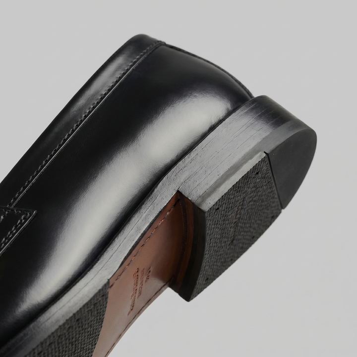 Men's black glossy penny loafers with rounded toes and low heels