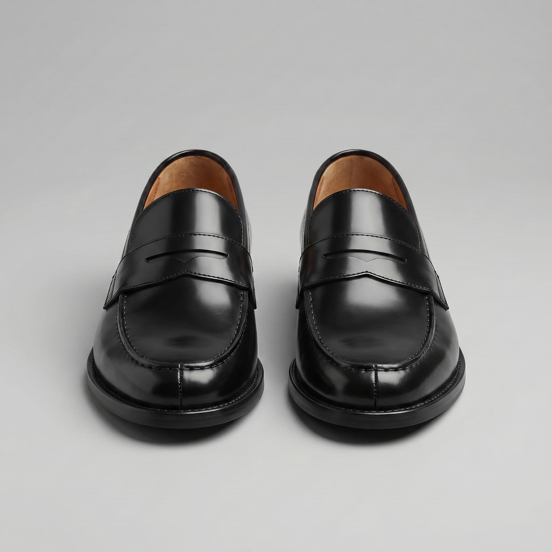 Men's black glossy penny loafers with rounded toes and low heels