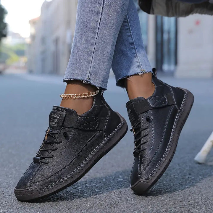 Women's lace-up sneakers with stitched panels and flat textured soles