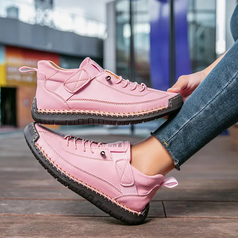 Women's lace-up sneakers with stitched panels and flat textured soles
