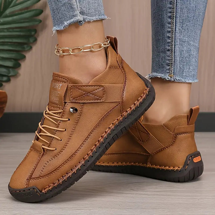 Women's lace-up sneakers with stitched panels and flat textured soles