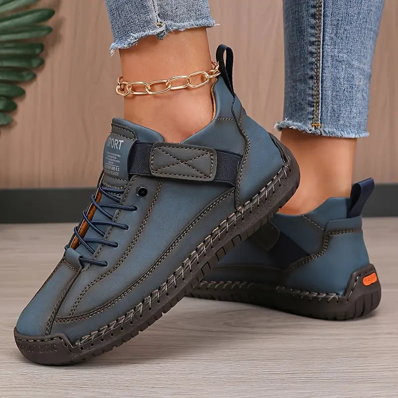 Women's lace-up sneakers with stitched panels and flat textured soles