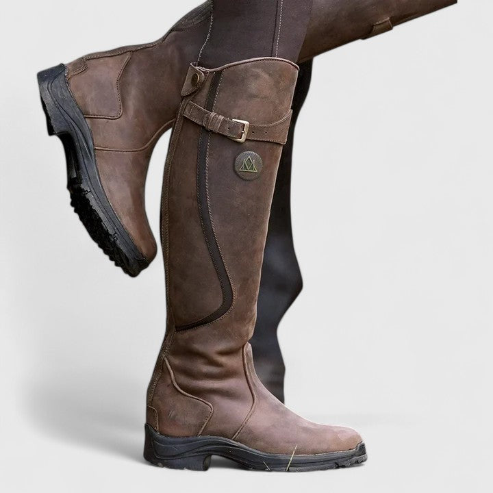 Women's cushioned orthopedic boots with adjustable buckle strap, suede-like upper, and grooved sole.