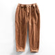 Men's ribbed corduroy pants with tapered legs and cuffed hems