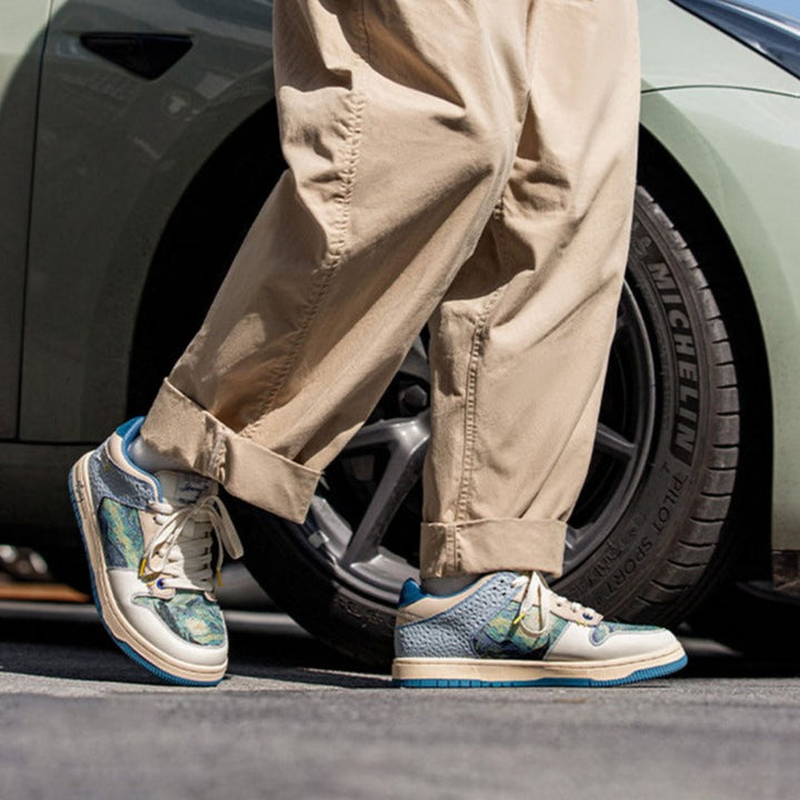 Low-top sneakers with abstract scenic artwork panels and blue soles
