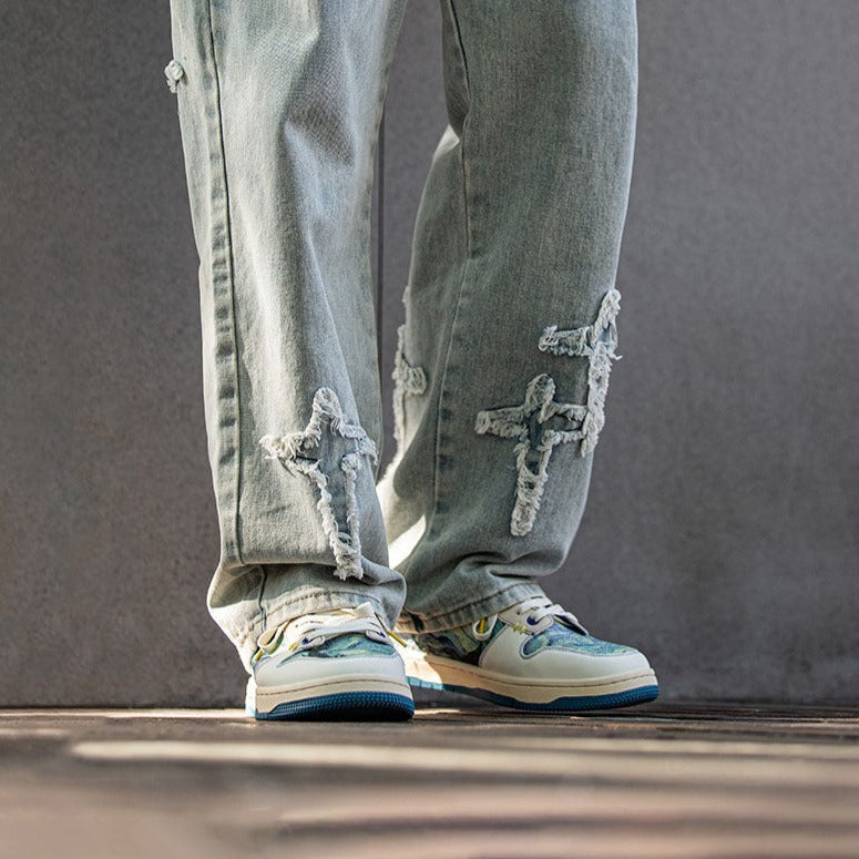 Low-top sneakers with abstract scenic artwork panels and blue soles
