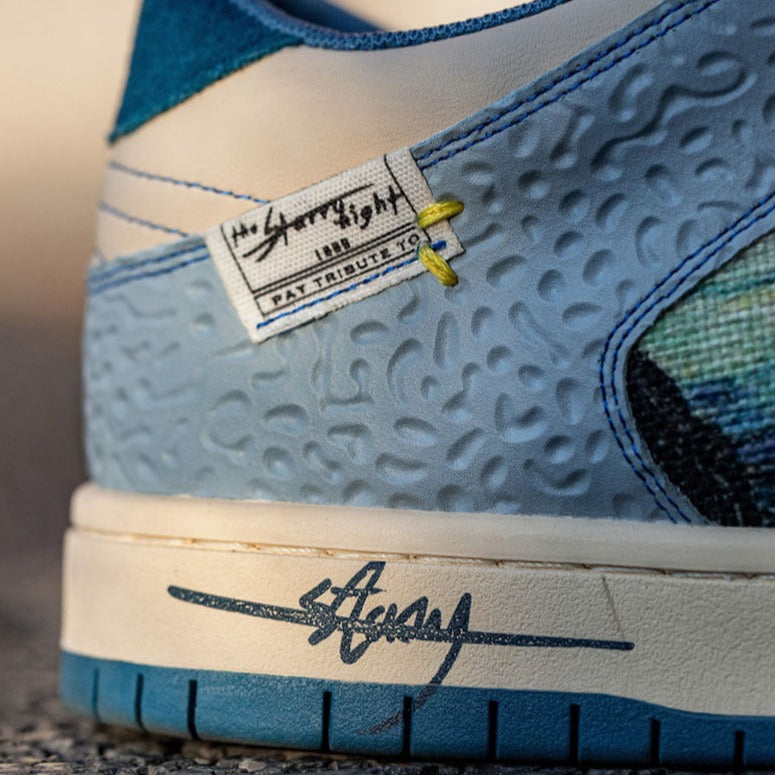 Low-top sneakers with abstract scenic artwork panels and blue soles