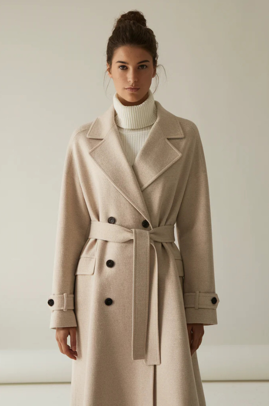 Women's long belted trench coat with lapels and button fastening