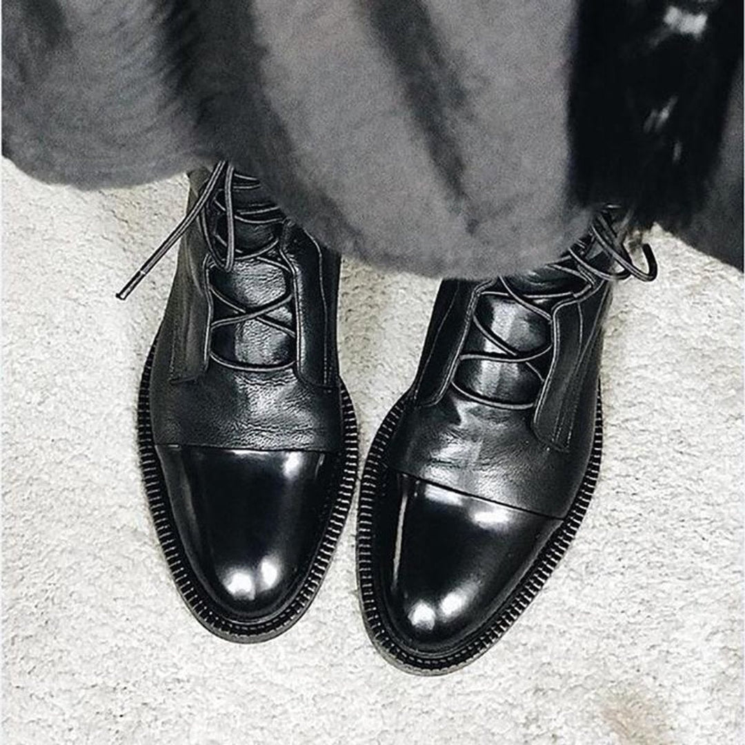 Women's lace-up boots with tall shafts, cap toe panels and low heels