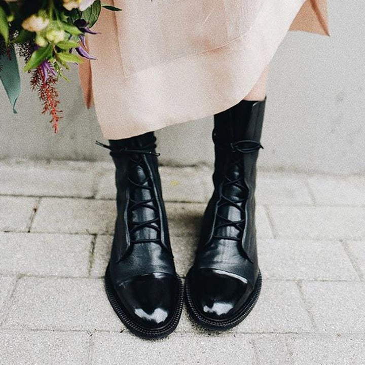 Women's lace-up boots with tall shafts, cap toe panels and low heels
