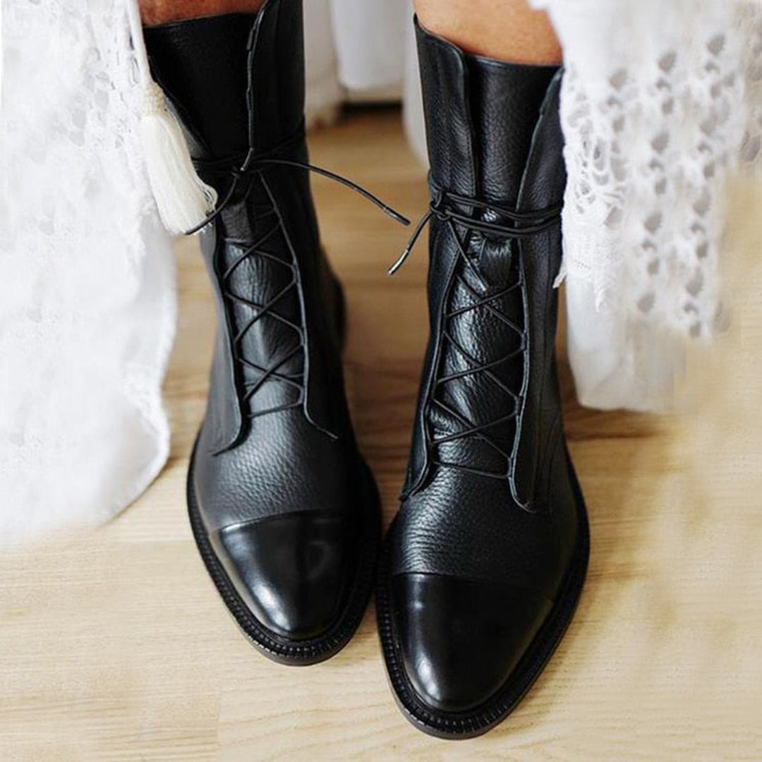 Women's lace-up boots with tall shafts, cap toe panels and low heels