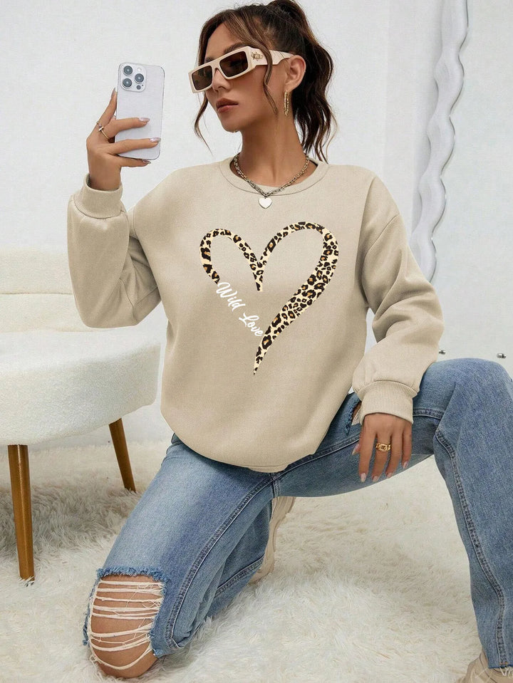Women's crew neck sweatshirt with leopard-print heart graphic and long sleeves