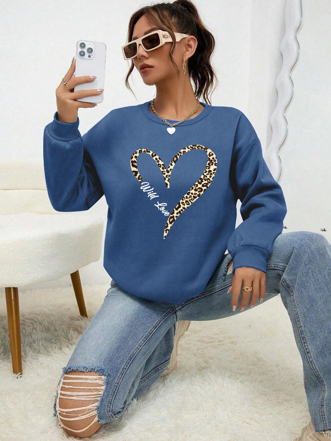 Women's crew neck sweatshirt with leopard-print heart graphic and long sleeves