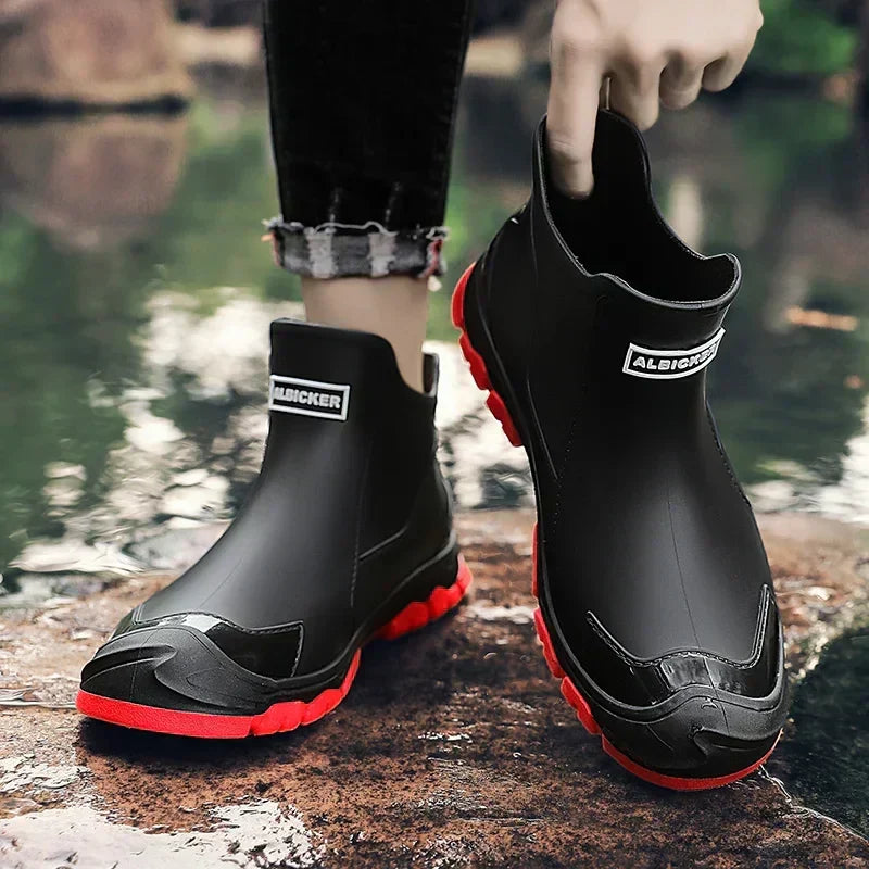 Women's waterproof ankle rain boots in slip-on style with textured tread sole and reinforced toe cap