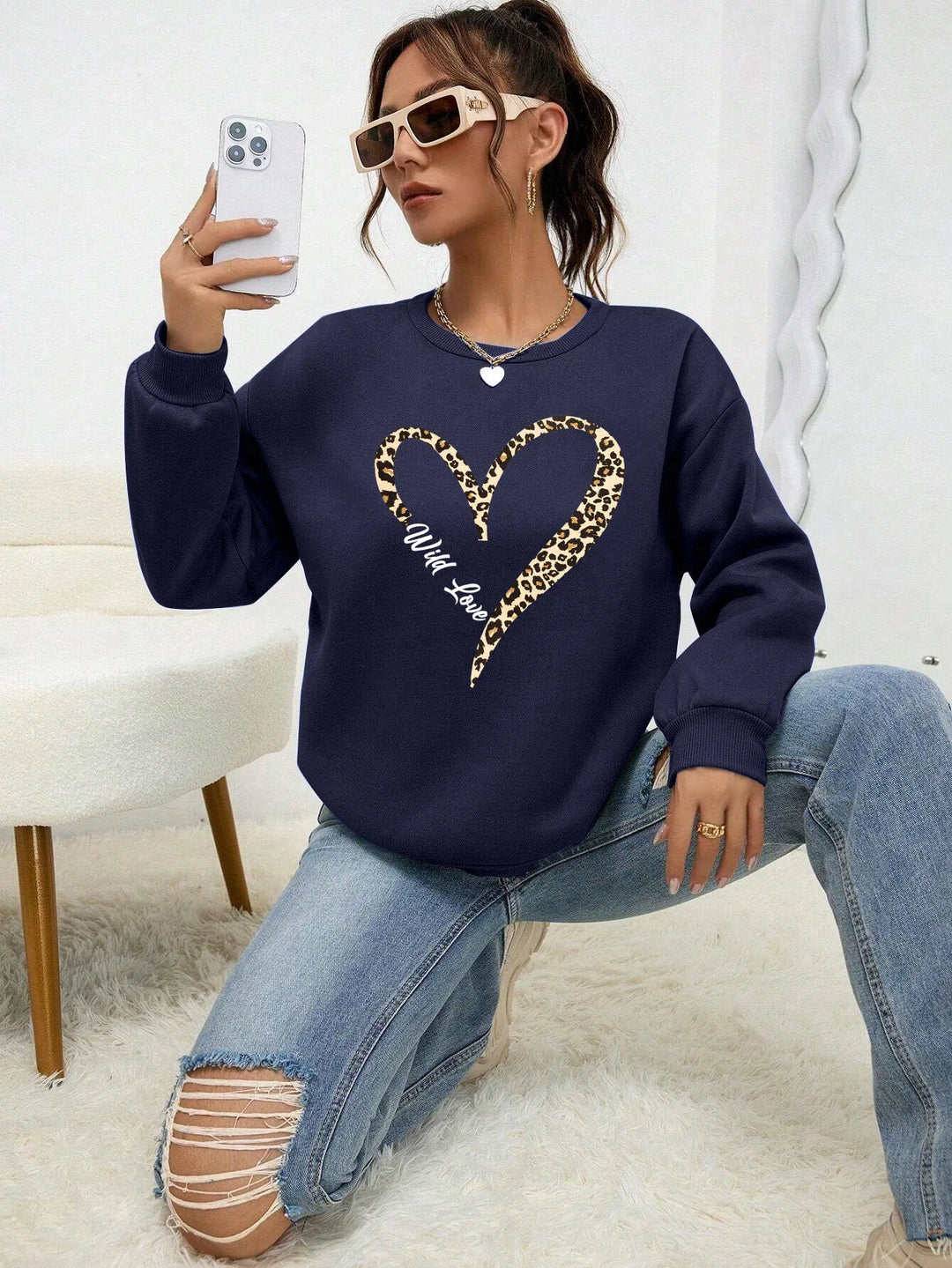 Women's crew neck sweatshirt with leopard-print heart graphic and long sleeves