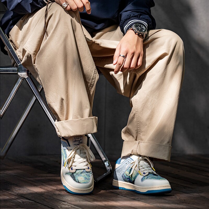 Low-top sneakers with abstract scenic artwork panels and blue soles