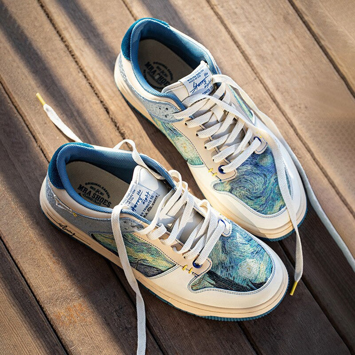 Low-top sneakers with abstract scenic artwork panels and blue soles