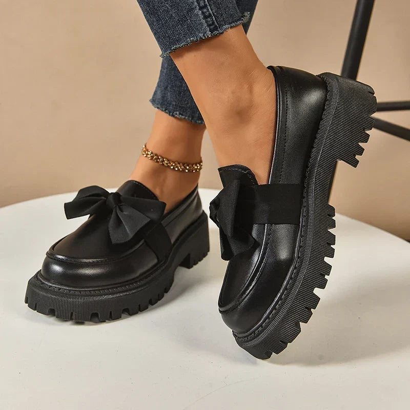 Women's chunky loafers with large bows, glossy uppers and black lug soles
