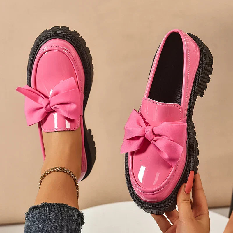 Women's chunky loafers with large bows, glossy uppers and black lug soles