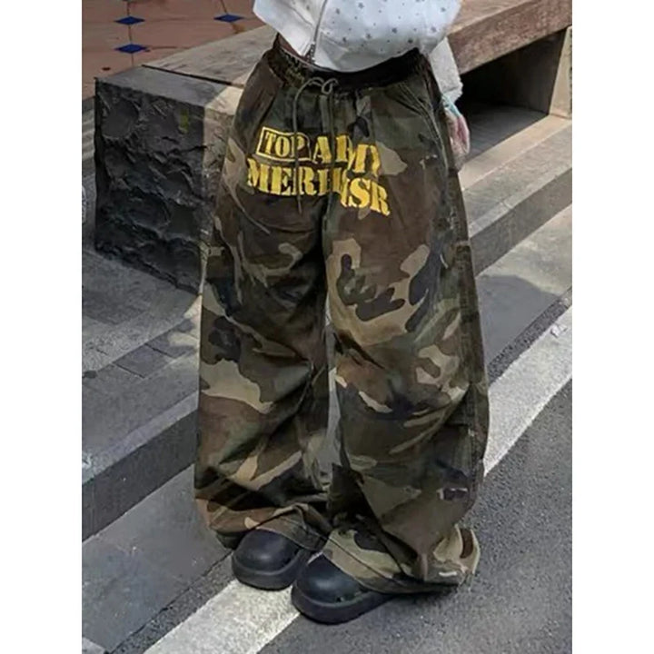 Baggy camouflage trousers with yellow front text and drawstring waist