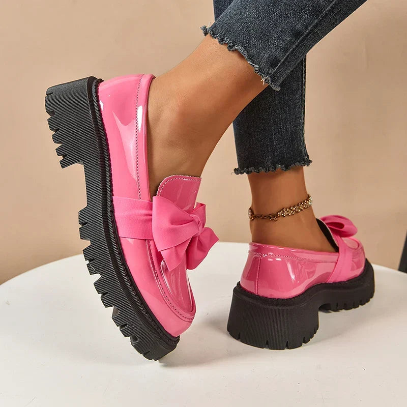 Women's chunky loafers with large bows, glossy uppers and black lug soles