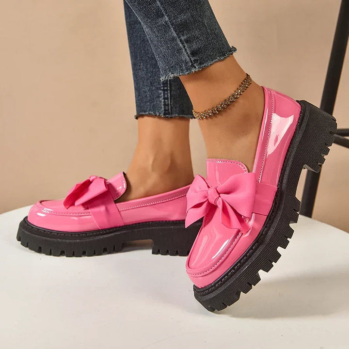Women's chunky loafers with large bows, glossy uppers and black lug soles