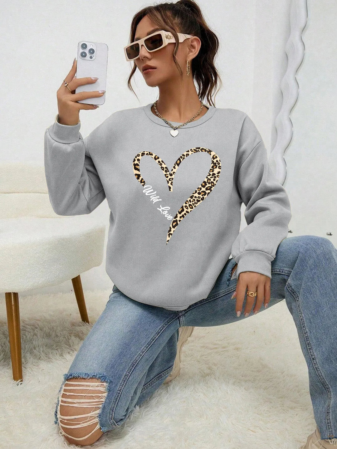 Women's crew neck sweatshirt with leopard-print heart graphic and long sleeves