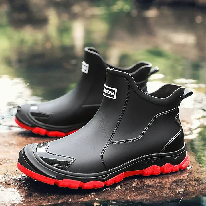Women's waterproof ankle rain boots in slip-on style with textured tread sole and reinforced toe cap