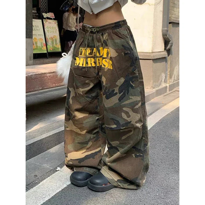 Baggy camouflage trousers with yellow front text and drawstring waist