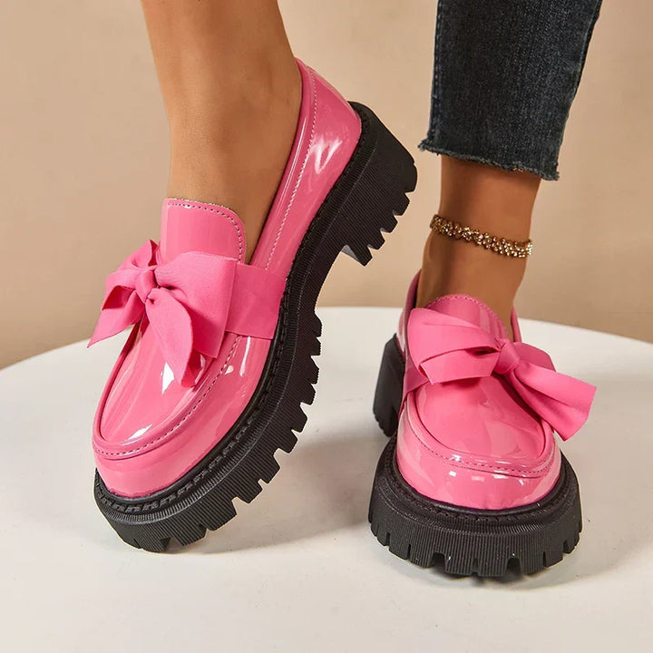 Women's chunky loafers with large bows, glossy uppers and black lug soles