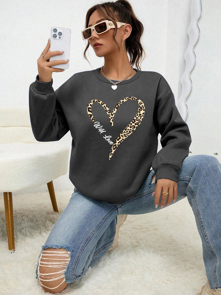 Women's crew neck sweatshirt with leopard-print heart graphic and long sleeves