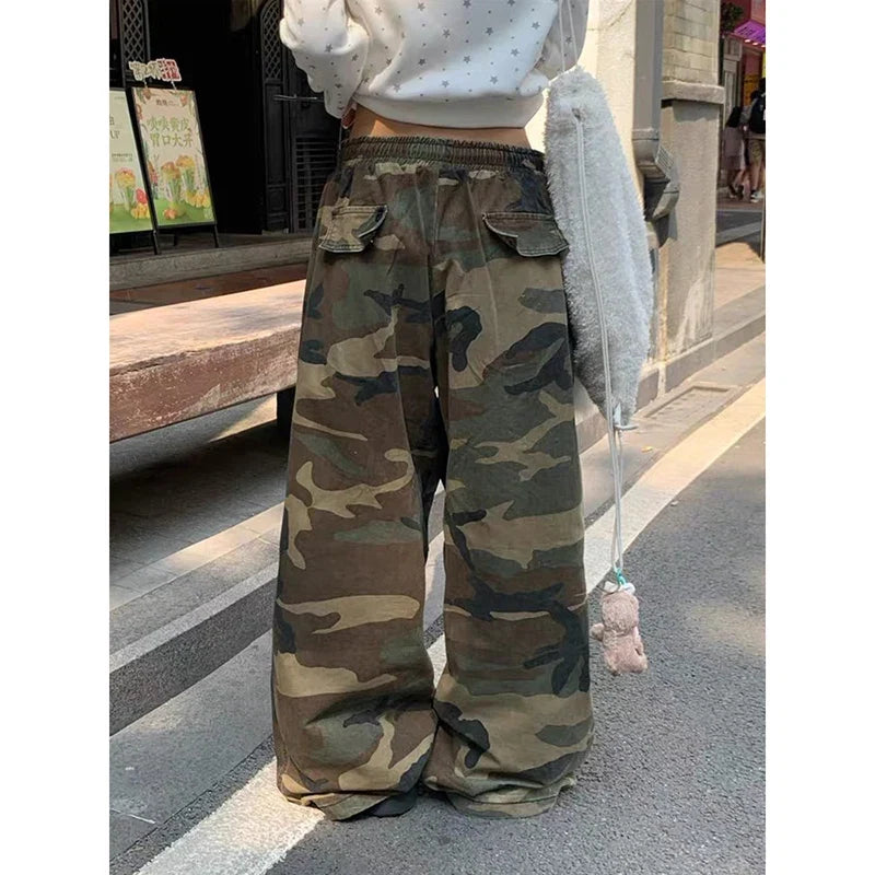 Baggy camouflage trousers with yellow front text and drawstring waist