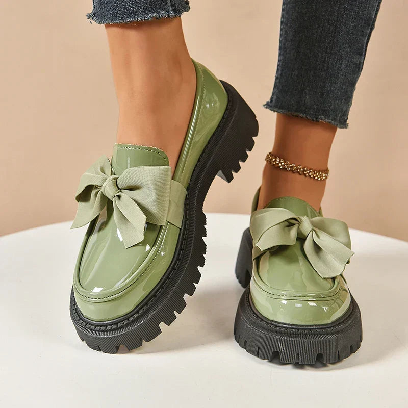 Women's chunky loafers with large bows, glossy uppers and black lug soles