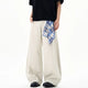 Cream wide leg trousers with elastic waistband and checked waist tie