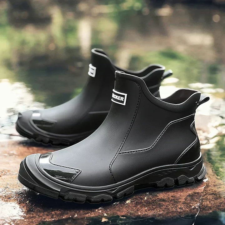 Women's waterproof ankle rain boots in slip-on style with textured tread sole and reinforced toe cap