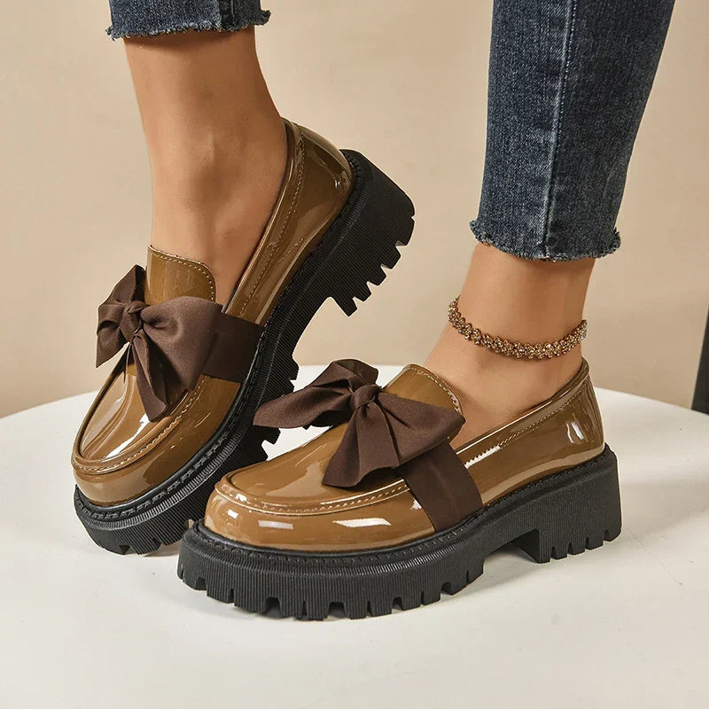 Women's chunky loafers with large bows, glossy uppers and black lug soles