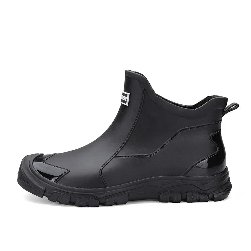 Women's waterproof ankle rain boots in slip-on style with textured tread sole and reinforced toe cap