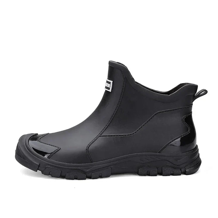 Women's waterproof ankle rain boots in slip-on style with textured tread sole and reinforced toe cap
